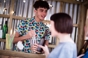Bar tender making a cocktail at street food market
