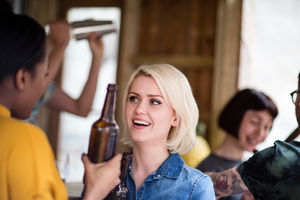 Group of friends at a street food bar drinking beer