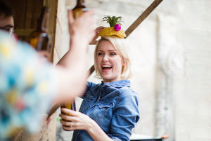 Young adult female posing with a pineapple on her head