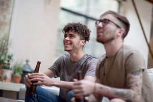 Two male friends watching sport