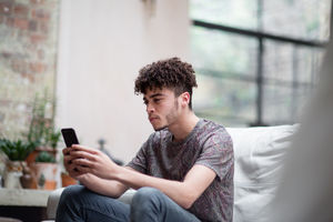 Young adult male on smartphone