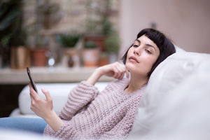 Young adult female looking thoughtful at home