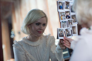 Young adult female looking at photos of friends