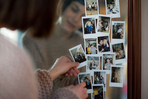 Young adult female looking at photos of friends