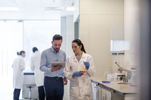 Female scientist discussing results of experiment with male colleague