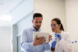 Female scientist discussing results of experiment with male colleague