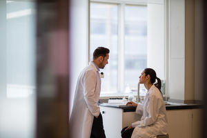 Female scientist discussing results of experiment with male colleague