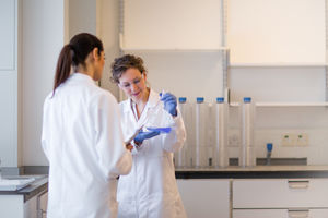Two female scientists discussing results of experiment
