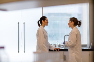 Two female scientists discussing results of experiment
