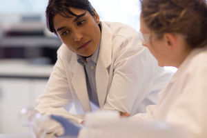 Close-up of two female scientists discussing results of experiment