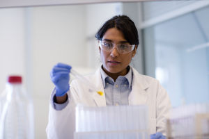 Female scientist analyzing test tube sample