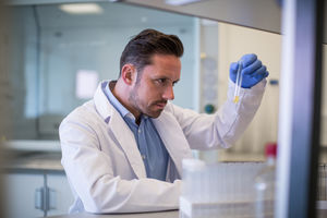 Male scientist looking at test tube in a laboratory