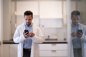 Male scientist using smartphone in laboratory