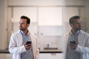 Male scientist using smartphone in laboratory