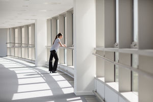 Businesswoman looking out of window in office
