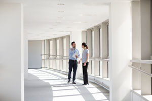 Businessman welcoming new employee to office