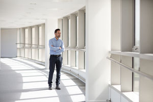 Businessman looking out of window in office