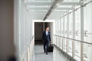 Businessman walking through airport terminal