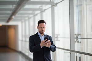 Businessman using smartphone app on his commute
