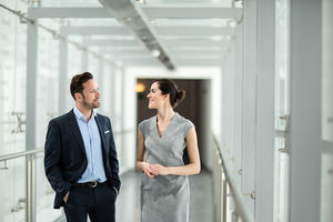Business colleagues walking through office corridor