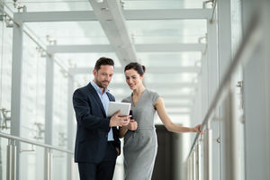 Business colleagues looking at digital tablet together