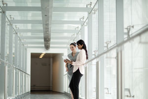 Business colleagues looking at digital tablet together