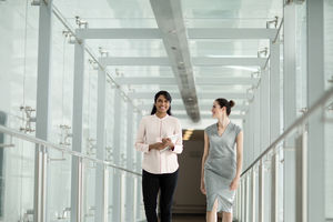 Business colleagues walking through office corridor
