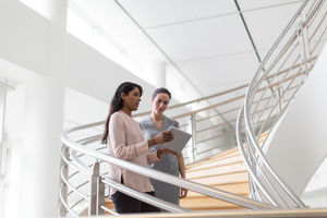 Business colleagues looking at digital tablet together