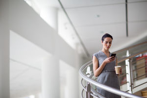 Businesswoman using smartphone app on her way to work