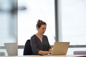 Female executive working in office on laptop