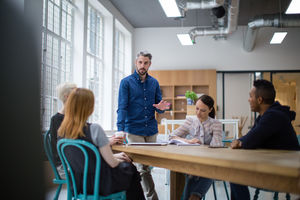 Businessman leading a meeting in creative office