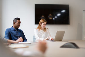 Female business executive setting up a presentation