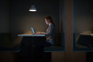 Businesswoman working late at night in office alone
