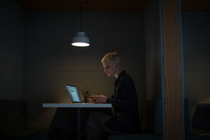 Businesswoman working late at night in office alone