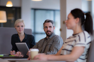 Businessman listening to female coworker in a meeting