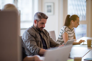 Freelancers working in a shared office deskspace 