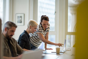 Manager training new employee in office