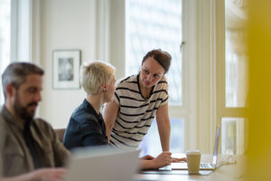 Manager training new employee in office