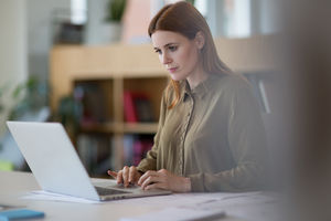 Female entrepreneur working on laptop