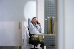 Stressed Medical Doctor on phone in his office