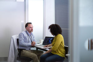 Male Medical Doctor explaining xray results to patient
