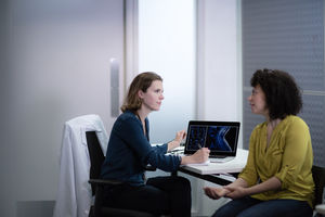 Female Medical Doctor listening to patient symptoms