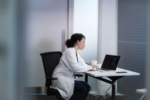 Female Medical Doctor looking at xray results on laptop