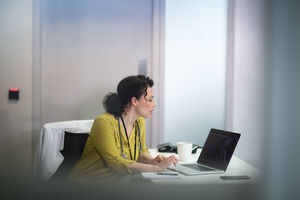 Female Medical Doctor looking at xray results on laptop