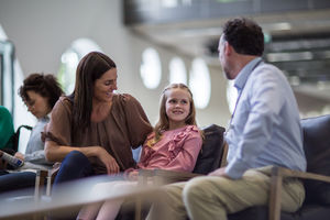 Mother and Child talking with Doctor in waiting room