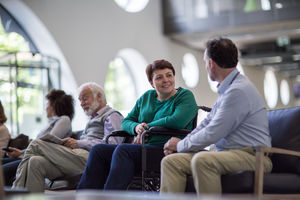Disabled woman talking with Doctor in waiting room