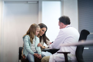 Family Doctor showing Mother and Daughter test results