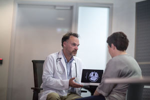 Male Medical Doctor explaining scan results to patient