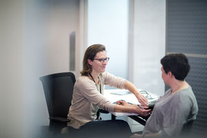 Female Medical Doctor taking an overweight patients blood pressure
