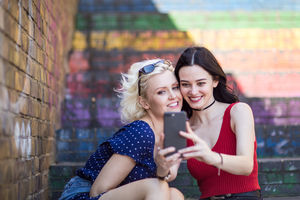 Female friends taking selfie in urban city